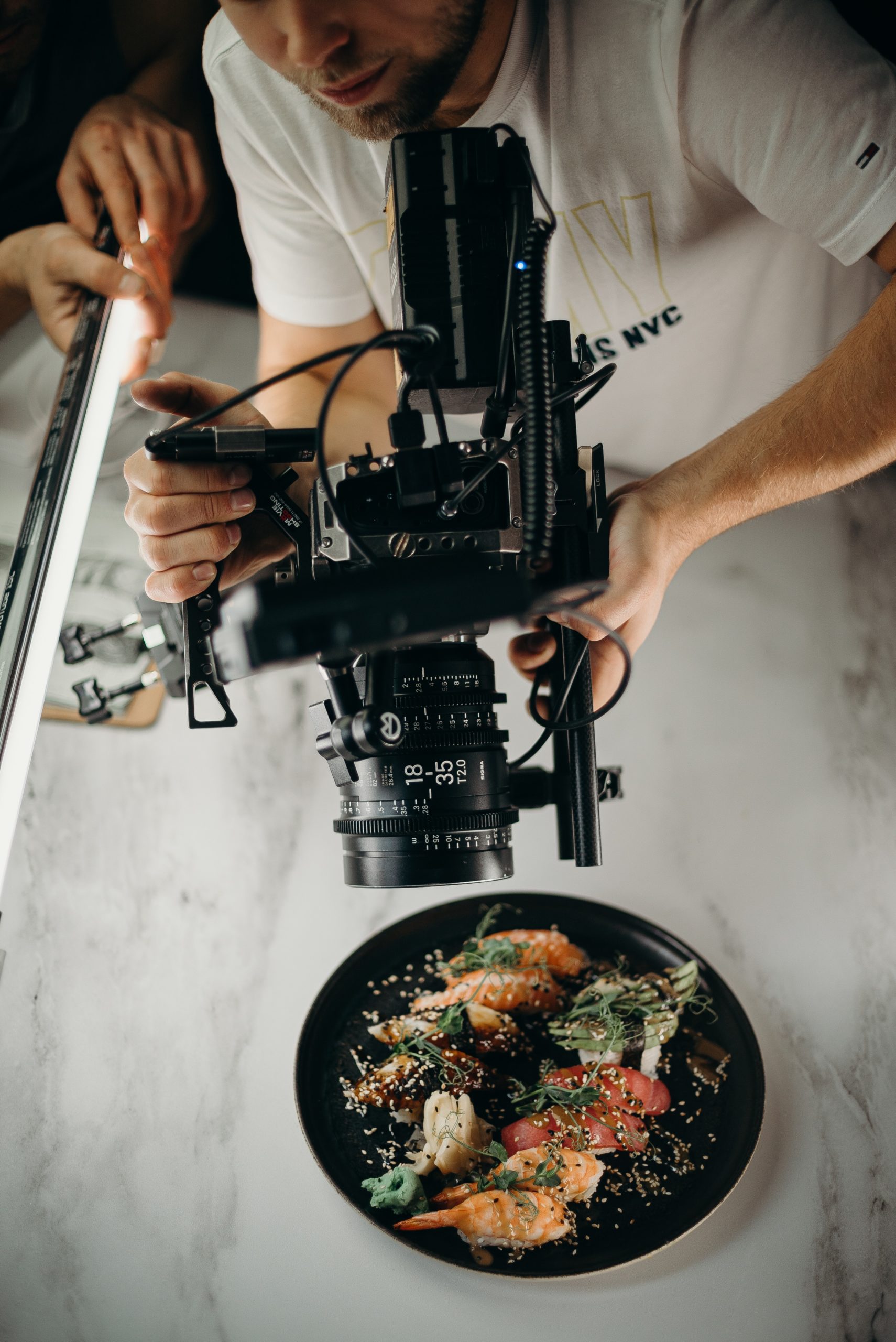 man-using-video-camera-pointing-on-food-on-plate-3298603
